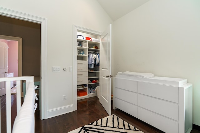 251 E Deshler Ave, Columbus, OH 43206 - bedroom featuring dark wood-style flooring, baseboards, a spacious closet, lofted ceiling, and a closet