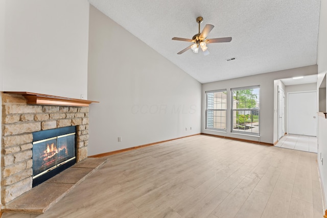 478 Three Oaks Ct, Columbus, OH 43230 - unfurnished living room with vaulted ceiling, a textured ceiling, a ceiling fan, a fireplace, and wood finished floors