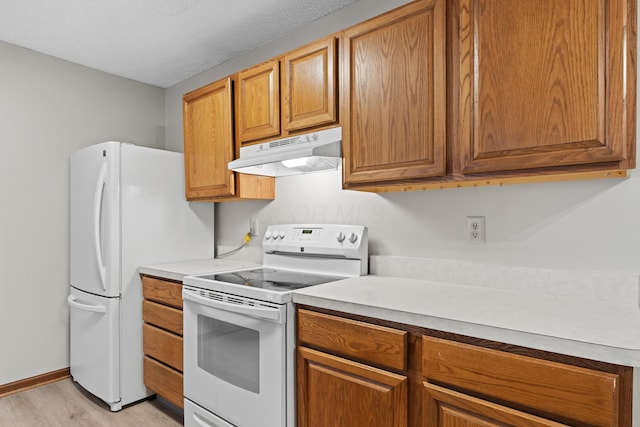 478 Three Oaks Ct, Columbus, OH 43230 - kitchen with white appliances, under cabinet range hood, light countertops, and brown cabinets
