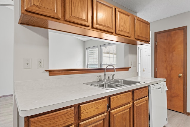 478 Three Oaks Ct, Columbus, OH 43230 - kitchen with a sink, white dishwasher, light wood-type flooring, light countertops, and brown cabinetry