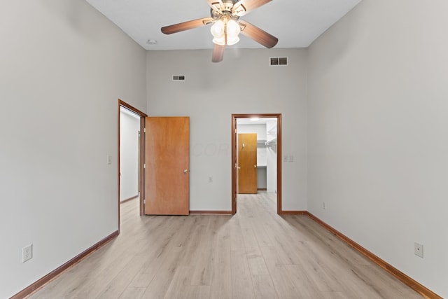 478 Three Oaks Ct, Columbus, OH 43230 - unfurnished bedroom with a spacious closet, light wood-style flooring, baseboards, a towering ceiling, and a closet