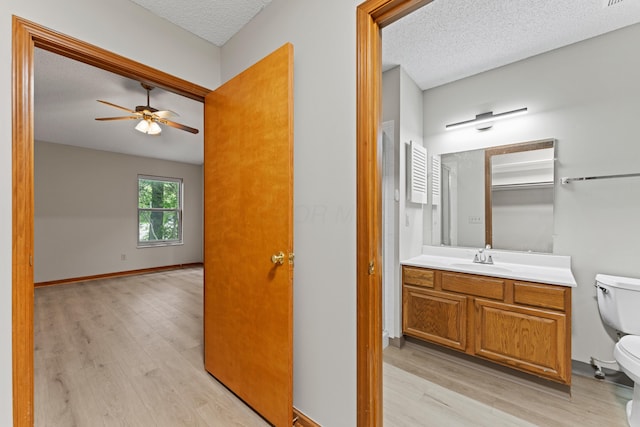 478 Three Oaks Ct, Columbus, OH 43230 - bathroom with toilet, wood finished floors, a ceiling fan, a textured ceiling, and vanity