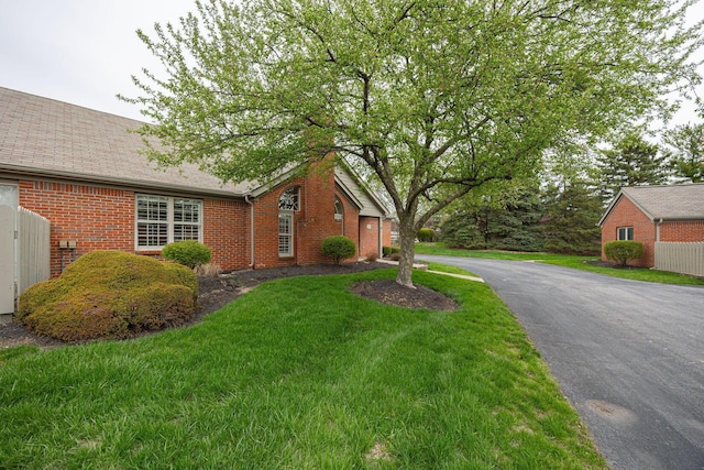 3870 Sandstone Cir, Powell, OH 43065 - view of front of house featuring brick siding, roof with shingles, and a front yard