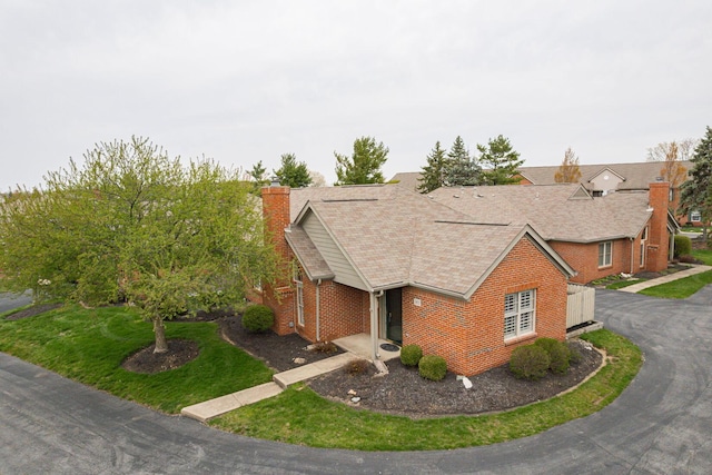3870 Sandstone Cir, Powell, OH 43065 - ranch-style home with brick siding, roof with shingles, and a chimney
