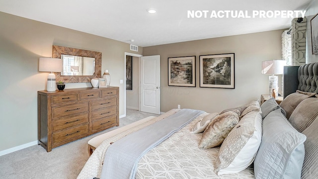 bedroom with light carpet, visible vents, and baseboards