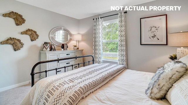 carpeted bedroom with baseboards