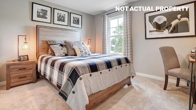 bedroom with baseboards and light carpet