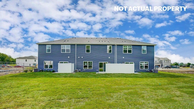 rear view of property featuring a yard, central AC, and fence