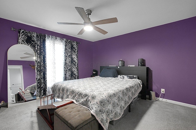 carpeted bedroom featuring baseboards and ceiling fan