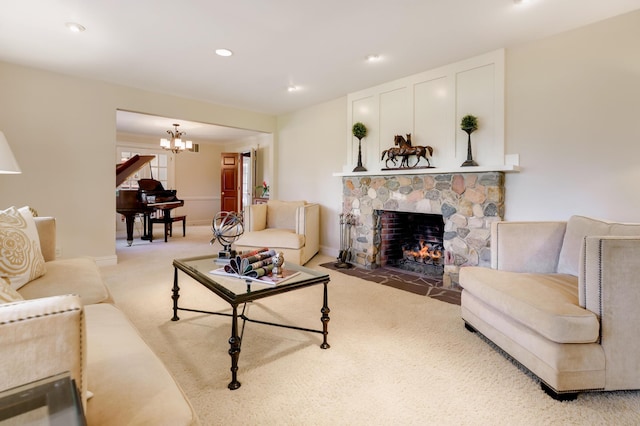 living area with light colored carpet, an inviting chandelier, a stone fireplace, and recessed lighting