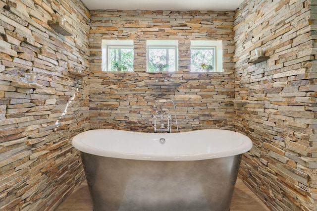 bathroom with a freestanding tub