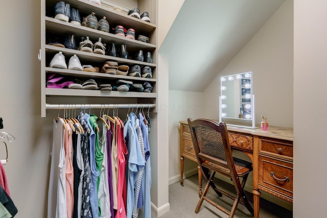 spacious closet with vaulted ceiling and carpet flooring