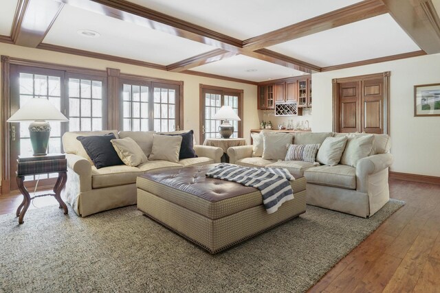 living room with indoor wet bar, coffered ceiling, hardwood / wood-style floors, and baseboards