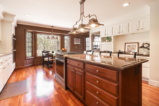 kitchen featuring white cabinets, stainless steel appliances, and a kitchen island