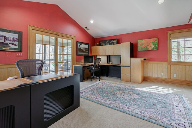 office with recessed lighting, a wainscoted wall, vaulted ceiling, visible vents, and light carpet