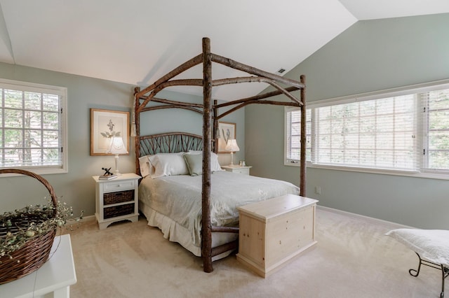 bedroom featuring vaulted ceiling, baseboards, light colored carpet, and multiple windows