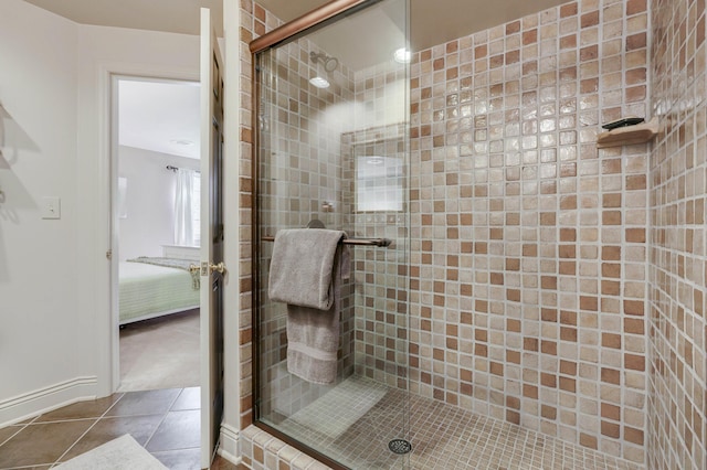 ensuite bathroom with ensuite bath, tile patterned flooring, and a stall shower