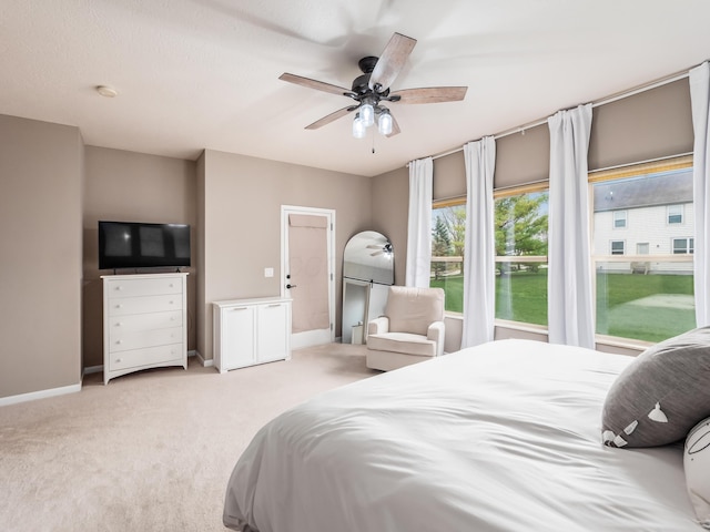 bedroom with carpet flooring, baseboards, and a ceiling fan