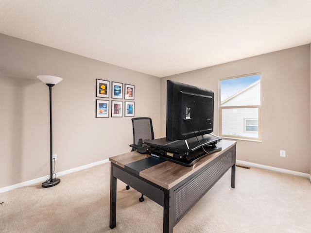 office featuring light colored carpet, baseboards, and visible vents