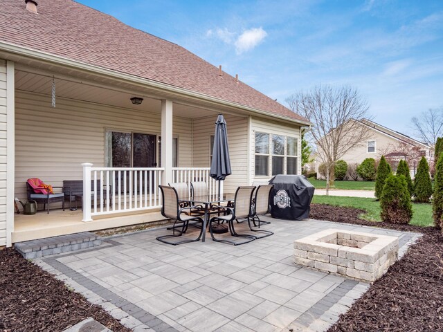 view of patio / terrace featuring an outdoor fire pit, grilling area, and a porch