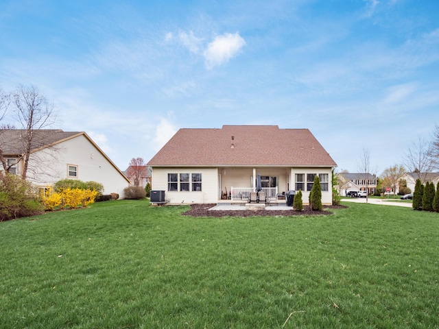 back of property featuring roof with shingles, a patio, a lawn, and central air condition unit