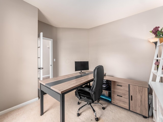 office space featuring baseboards and light colored carpet