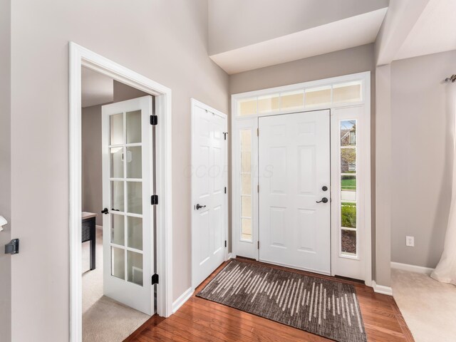 entryway featuring wood-type flooring and baseboards