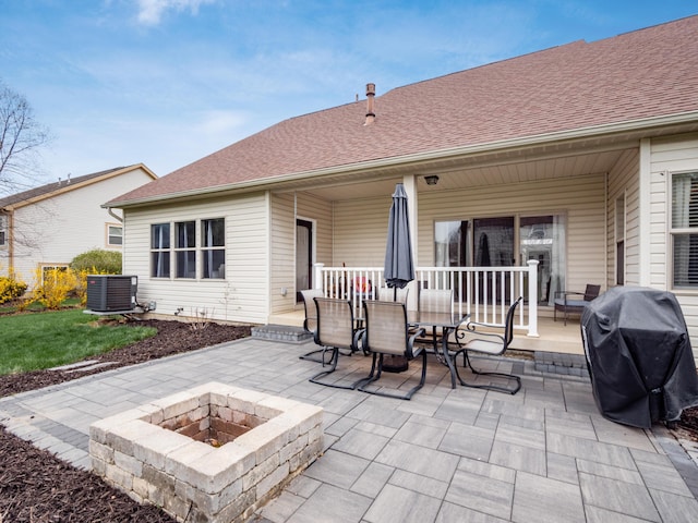 view of patio / terrace with central AC, a porch, a grill, and a fire pit