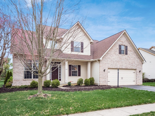 traditional-style house featuring a garage, brick siding, driveway, and a front lawn