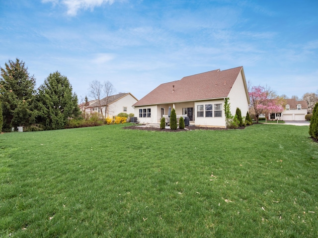 back of property featuring a yard