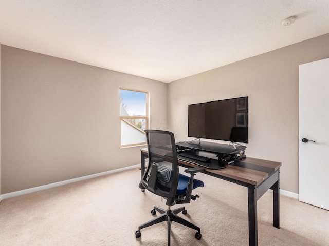 office featuring light carpet and baseboards