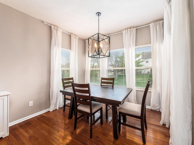 dining room with a wealth of natural light, a notable chandelier, baseboards, and dark wood-style floors