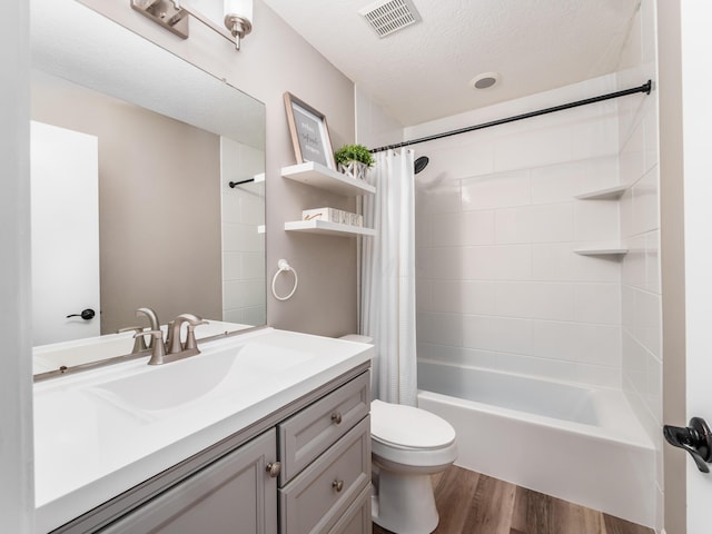 full bath with vanity, visible vents, toilet, wood finished floors, and shower / bath combo with shower curtain