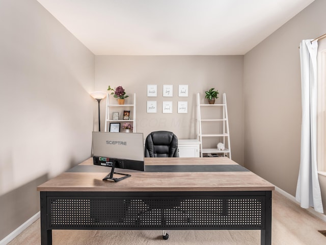 office area featuring light colored carpet and baseboards