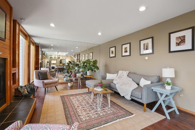 living area with recessed lighting, baseboards, and wood finished floors