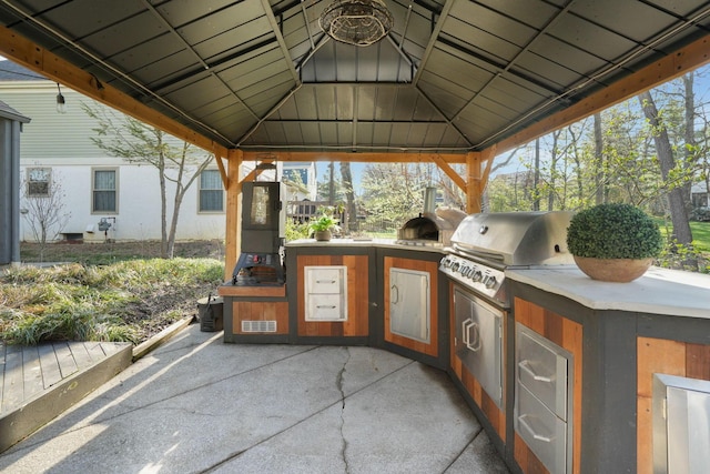 view of patio / terrace featuring an outdoor kitchen, a gazebo, and area for grilling