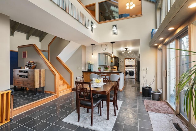 dining space featuring washer and clothes dryer, stairs, beam ceiling, and high vaulted ceiling