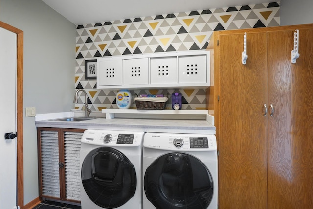 laundry room with a sink, cabinet space, and washer and dryer
