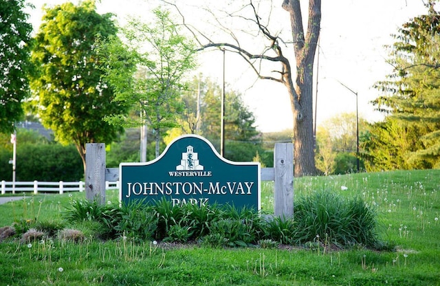 community sign featuring fence