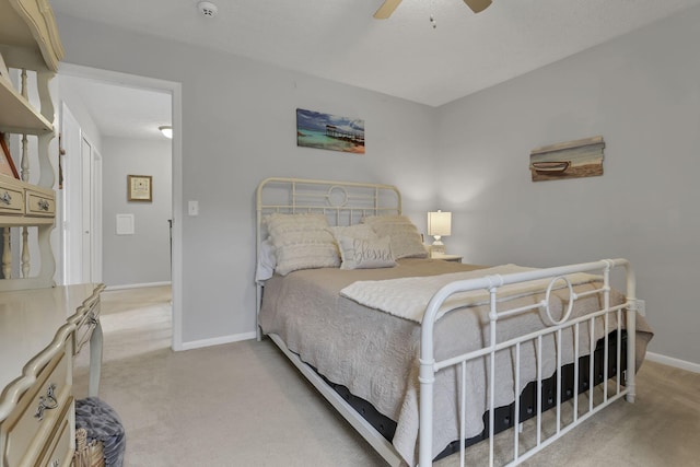 carpeted bedroom featuring a ceiling fan and baseboards