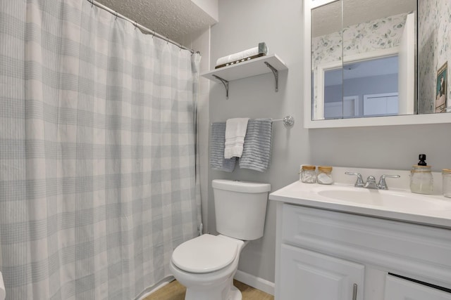 bathroom with vanity, a textured ceiling, and toilet