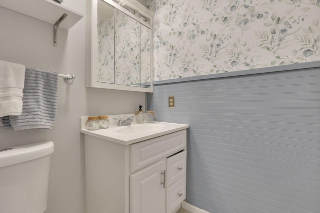 bathroom featuring vanity and toilet