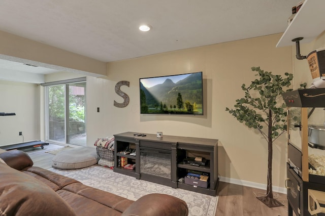 living room with recessed lighting, baseboards, visible vents, and wood finished floors