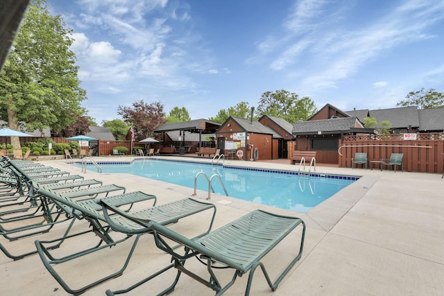 community pool featuring a patio, a gazebo, and fence