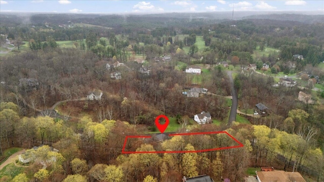 birds eye view of property with a view of trees