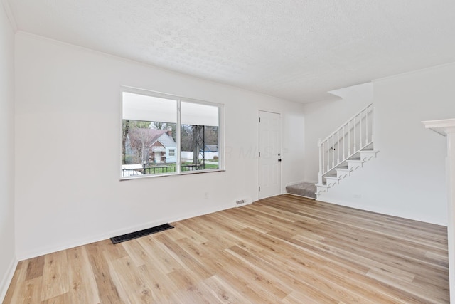 1381 Oakwood Ave, Columbus, OH 43206 - interior space with visible vents, a textured ceiling, wood finished floors, and stairway
