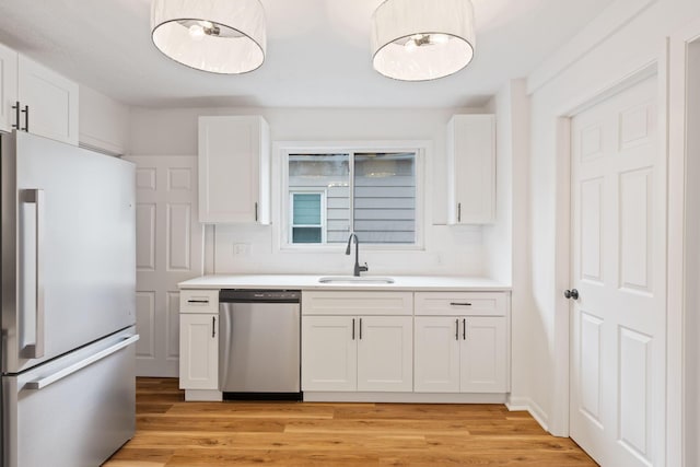 1381 Oakwood Ave, Columbus, OH 43206 - kitchen featuring a sink, white cabinetry, light countertops, and appliances with stainless steel finishes