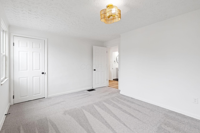 1381 Oakwood Ave, Columbus, OH 43206 - unfurnished bedroom with baseboards, carpet floors, and a textured ceiling