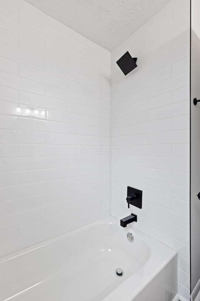 1381 Oakwood Ave, Columbus, OH 43206 - bathroom featuring a textured ceiling and bathtub / shower combination