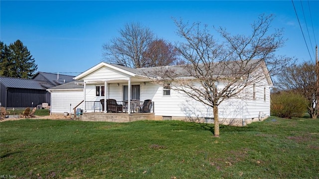 rear view of property with a lawn, covered porch, and crawl space